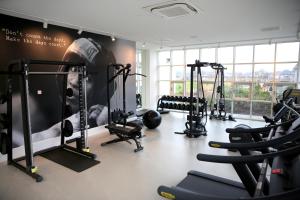 a gym with several treadmills and exercise bikes at Van der Valk Hotel Apeldoorn in Apeldoorn