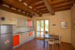 a kitchen with a table and a refrigerator at Il Casale in Capoliveri