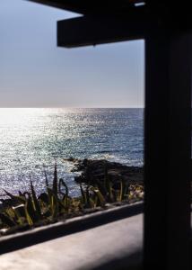 a view of the ocean from a window at Villa calypso Pantelleria in Pantelleria