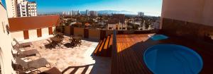 a balcony with chairs and a view of a city at Gran Continental Hotel Taubaté in Taubaté