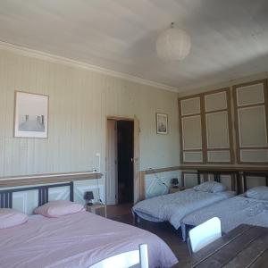 a bedroom with two beds and a room with at Relais des castors in Murat