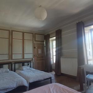 a bedroom with two beds and a ceiling at Relais des castors in Murat