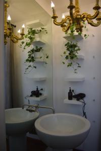 a bathroom with a white sink and a mirror at House System in Giarre