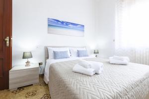 Postel nebo postele na pokoji v ubytování Lupomonaco Rooms