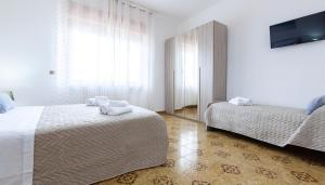 Postel nebo postele na pokoji v ubytování Lupomonaco Rooms