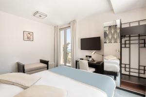 a bedroom with a bed and a desk and a tv at Best Western Hôtel Journel Antibes Juan-les-Pins in Antibes