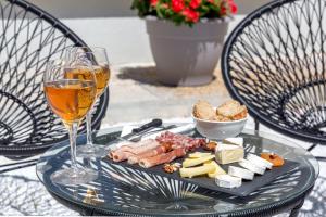 a plate of food and a glass of wine on a table at Best Western Hôtel Journel Antibes Juan-les-Pins in Antibes