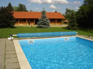 a large swimming pool in front of a house at Kerca Bio Farm in Kercaszomor