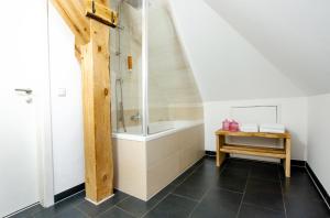 a bathroom with a shower and a bath tub at Design Apartments - "Im Holländerviertel" in Potsdam