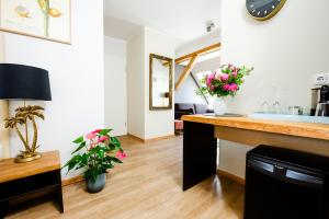 a room with a counter with flowers on it at Design Apartments - "Im Holländerviertel" in Potsdam