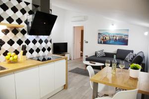 cocina y sala de estar con mesa en Apartments Perkovic, en Fažana