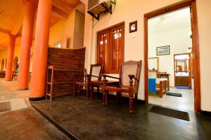 a room with a table and chairs in a building at International Beach Hotel & Restaurant in Hikkaduwa