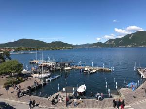 a group of people walking around a dock on a lake at Iseo Vista Lago in Iseo