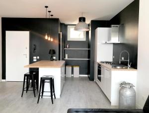 a kitchen with white appliances and black walls at Iseo Vista Lago in Iseo