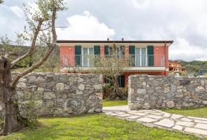 a house with a stone wall and a fence at ARIA Design B&B Levanto in Levanto