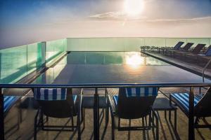 a ping pong table on a cruise ship with chairs at Miramar By Windsor Copacabana in Rio de Janeiro