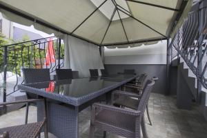 a patio with a table and chairs and an umbrella at Pokoje i Restauracja Jantarowa in Jantar +15 photos