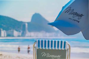 a blue and white chair on the beach at Miramar By Windsor Copacabana in Rio de Janeiro