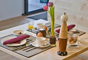 a table with a table set with eggs and flowers at Hotel Talblick in Saalbach-Hinterglemm