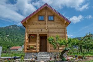 a log cabin with a front door and windows at Wood House in Virpazar