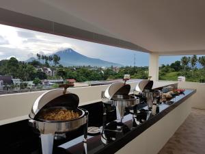 a buffet line with a view of a mountain at VICTORIA INN in Paniki
