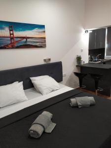 a bedroom with a bed with a bridge painting on the wall at Takis apartments in Ayia Napa