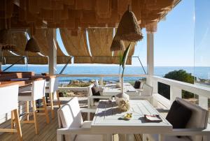 a restaurant with tables and chairs and a view of the ocean at Vila Joya in Albufeira