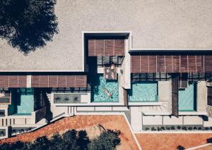 an aerial view of a building with a swimming pool at Monastery Estate Retreat in Sougia
