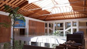a living room with chairs and a glass ceiling at Hipotels Barrosa Park in Chiclana de la Frontera