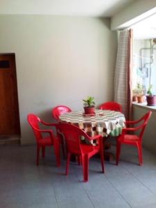 a red table and chairs in a room at KAPANA in Mtskheta +52 photos