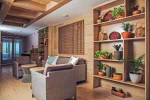 a living room with chairs and plants on shelves at Windsor California Copacabana in Rio de Janeiro