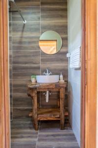 a bathroom with a sink and a mirror at Wood House in Virpazar +21 photos
