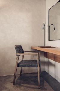 a wooden chair sitting next to a wooden desk at Monastery Estate Retreat in Sougia