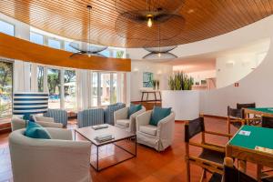 a living room with couches and a table at Apartamentos Turisticos Pinhal Da Marina in Vilamoura