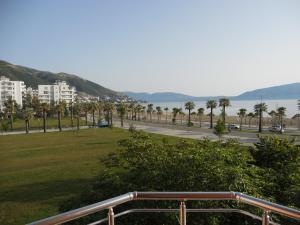 a view of a park with palm trees and a road at Onorato Hotel in Vlorë