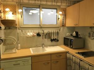 a kitchen with a sink and a microwave at Quiet flat next to the beach in Nice