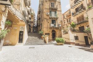 an empty street in an old building with stairs at Camere a Sud in Agrigento