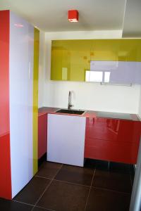 a kitchen with colorful cabinets and a sink at Hotel Grey in Luxembourg