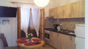 a kitchen with a small table and a kitchen with a refrigerator at St Paul and Peter's House in Asprovalta