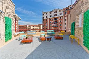 a patio with tables and chairs on a building at Camplus Pamplona in Pamplona