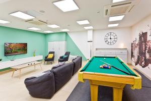 a billiard room with a pool table and couches at Camplus Pamplona in Pamplona