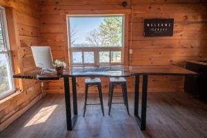a desk in a log cabin with a computer on it at The Trace at Oak Lake (19+) in Havelock