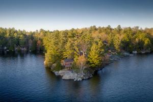 a house on an island in the middle of a lake at The Trace at Oak Lake (19+) in Havelock