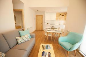 a living room with a couch and a table at Apartamentos Arumes do Mar e Montaña - Viveiro in Viveiro