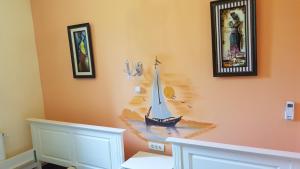 a wall with a painting of a boat on it at Hotel-Hostel Mignon Mamaia -private rooms with free parking in Mamaia