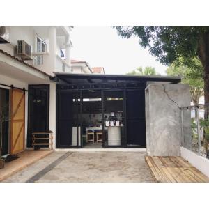 a building with a black garage with a table in it at haus_22 in Bukit Mertajam