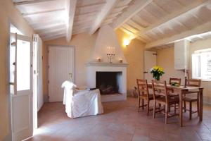 a living room with a table and a fireplace at Villa Sant'Elena in Morro dʼAlba