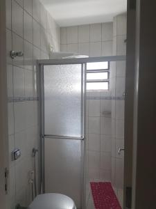 a bathroom with a shower and a toilet in it at CONFORTO e SEGURANÇA AP11 in Guaratuba +8 photos