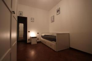 a bedroom with a bed and a night stand with a lamp at La Casa nel Bosco in Savio di Ravenna