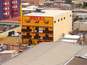 a yellow building on top of a city at Hotel Brasília Park in Novo Gama